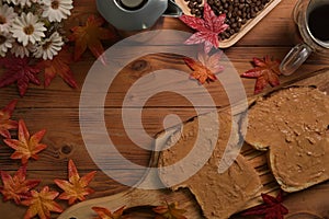 Peanut butter sandwich or toasts in plate and coffee cup on the wooden table.