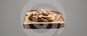 Peanut butter on whole wheat toast with peanuts