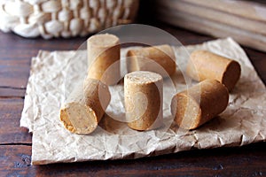 Peanut candy paÃÂ§oca or pacoca traditional Brazilian sweet based on peanuts, manioc flour and sugar on a rustic wooden table photo