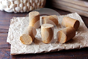 Peanut candy paÃ§oca or pacoca traditional Brazilian sweet based on peanuts, manioc flour and sugar on a rustic wooden table