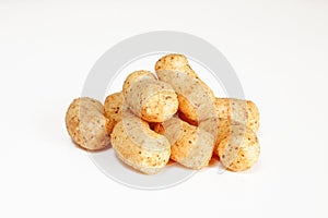 Peanut flips isolated on white background. Pile of snack food close-up