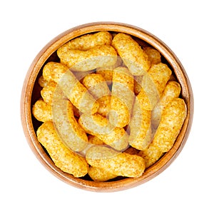 Peanut flips, puffed peanut-flavored corn snack, in a wooden bowl