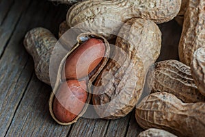 Peanut in nutshell on wooden background. Composition of peanuts