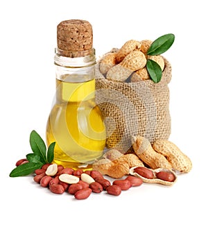 Peanut oil in a glass bottle with peanuts in bag