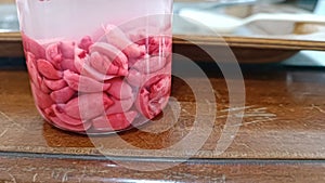 Peanut Seeds Inside a Bottle Containing Tetrazolium Solution Resulting in Red-Colored Seeds