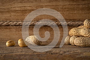 Peanut in a shell on wooden background. Food background. Top view