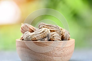 Peanut in wooden bowl and nature green background Boiled peanuts