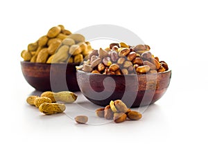 Peanut in wooden bowl on a white background.