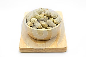 Peanut on wooden plate on white background