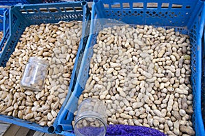 Peanuts and almonds in the shell in plastic boxes