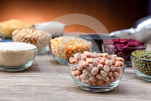 Peanuts in a bowl wood table. The peanut also known as the groundnut  or goober or monkey nut is a legume crop grown mainly for it