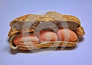 Peanuts with open shells on a white background.