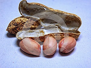 Peanuts with open shells on a white background.