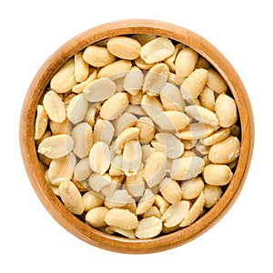 Peanuts, roasted and salted, in wooden bowl, over white