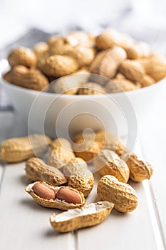 Peanuts in shell. Groundnuts on white table