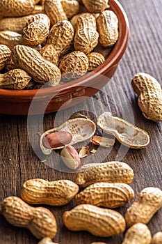 Peanuts in shell. Groundnuts on wooden table