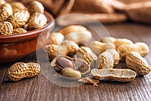 Peanuts in shell. Groundnuts on wooden table