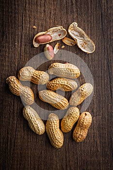 Peanuts in shell. Groundnuts on wooden table. Top view