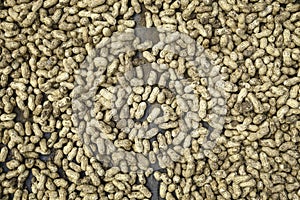 Peanuts in shell texture background. Raw peanuts on display at a farmer`s market. Close up image