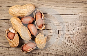 Peanuts in shells on wood background