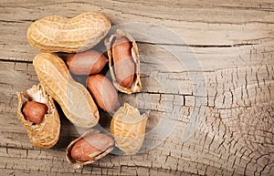 Peanuts in shells on wood background photo