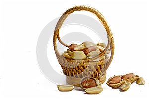 Peanuts in small wicker basket and isolated on white