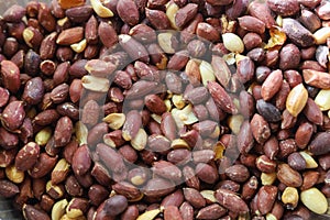 Peanuts with unpeeled hulls. Nuts background with selective focus