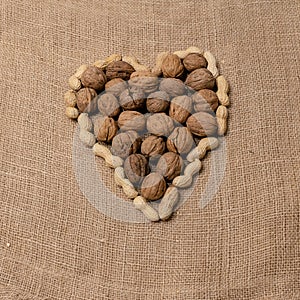 Peanuts and walnuts arranged to form a heart. photo