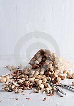 Peanuts, walnuts are in a yuta bag on a delicate background photo