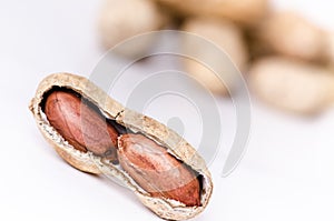 Peanuts on a white background. . Building from nuts. Balance. Open shell. Nutrition. Peanuts butter