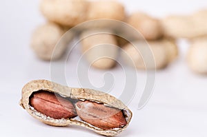 Peanuts on a white background. Isolated. Building from nuts. Balance. Open shell. Nutrition. Peanuts butter