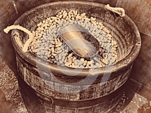 Peanuts wooden barrel full of nuts and a scoop retro vintage background