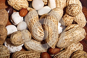 Peanuts in wooden dish with candy closeup macro