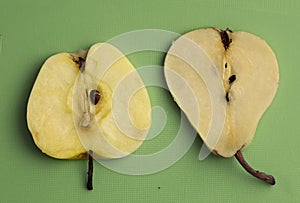 Pear and apple close up photo on green kitchen board