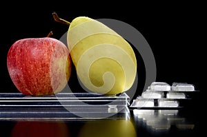 Pear and apple on a tray and medicine