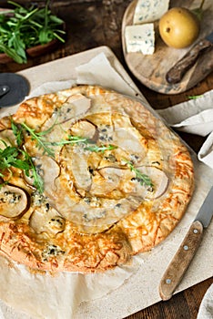 Pear and blue cheese quatro formaggi pizza garnished with arugula