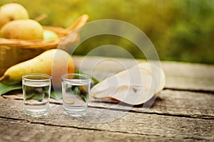 Pear brandy and pears on the table