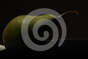 PEAR IN CLOSE-UP WITH DARK BACKGROUND photo