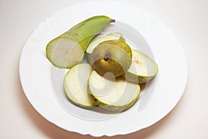 Pear conference, cut into thin slices, beautifully arranged on white plate. back and front parts are bigger