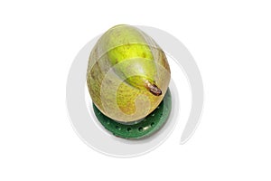 Pear conference on green round stand, made of rubber hand expander tool, isolated on white background. half green, with gray-brown