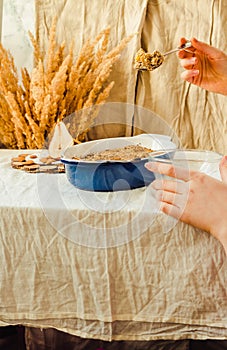 Pear crumble cake in blue baking dish. Linen tablecloth autumn c