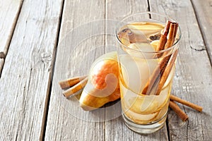 Pear, ginger, cinnamon detox water against rustic wood