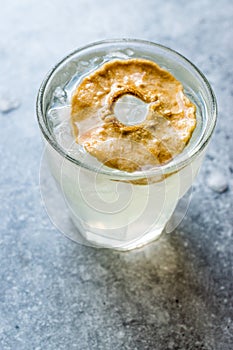 Pear Juice Cocktail with Dried Pear Slice and Crushed Ice.