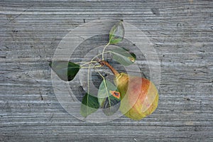 Pear with leaves on a wooden table