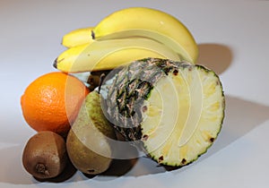 Pear, orange, kiwi, pineapple and banana compositon.