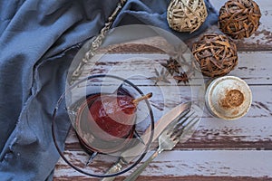 Pear with red wine served in a glass bowl in rustic presentation on a wooden table