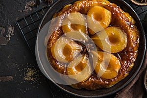 Pear tart tatin, french caramel pear cake, dark background