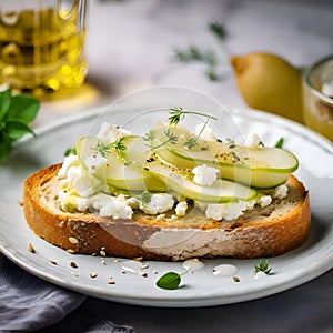 Pear toast. Bruschetta with pear, honey, walnut and cottage cheese served on a white plate on a light grey background. Pear and