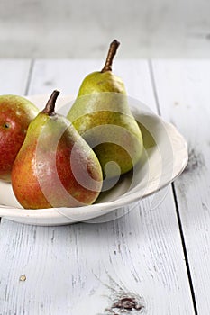 Pear white plate and wooden table