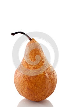 A pear on a white reflective surface